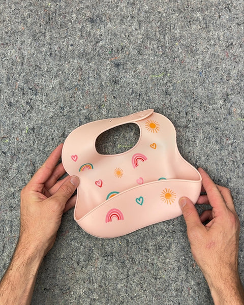 Pink Silicone Baby Bib with Rainbow and Sun Design