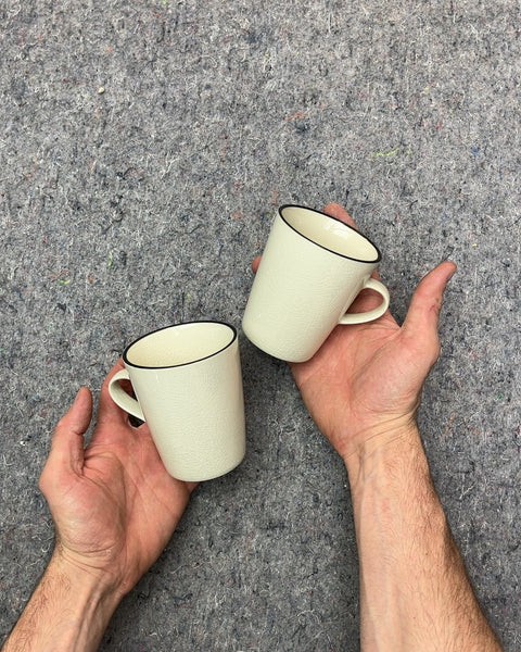 Two Pretty Crate & Barrel Cream Textured Mugs with Black Rim