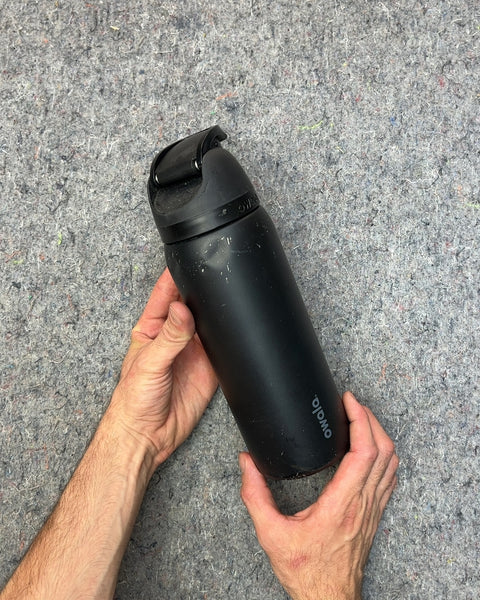 Owala Black Water Bottle That Looks Like It Felt Down The Stairs Or Something