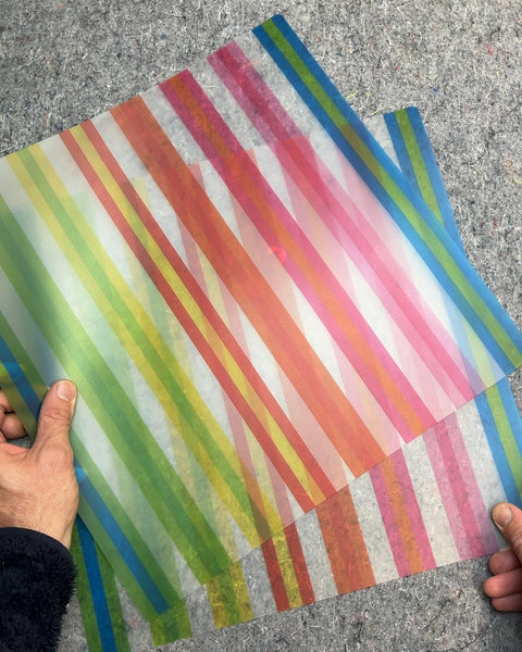 Two Rainbow Striped Plastic Placemats