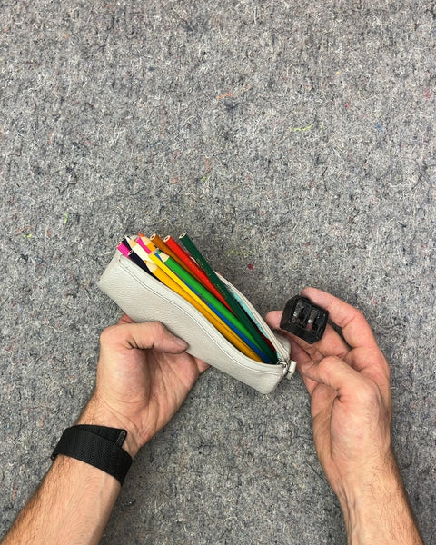 White Pencil Case with Colored Pencils and Sharpener