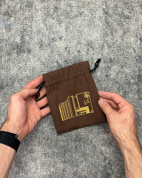 Brown Drawstring Pouch with Gold Building Graphic