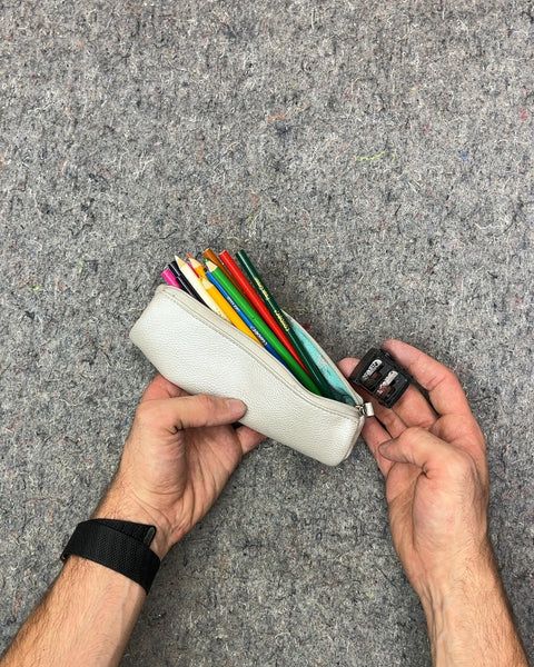 White Pencil Case with Colored Pencils and Sharpener