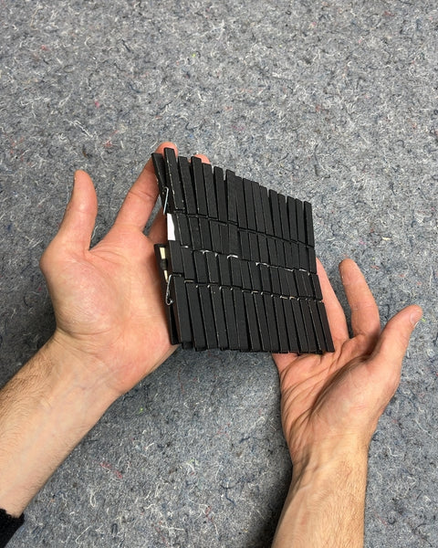 A Bunch Of Black Wooden Clothespins