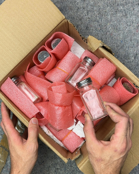 A Box Full Of Spice Shakers