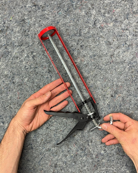 Red and Black Caulk Gun