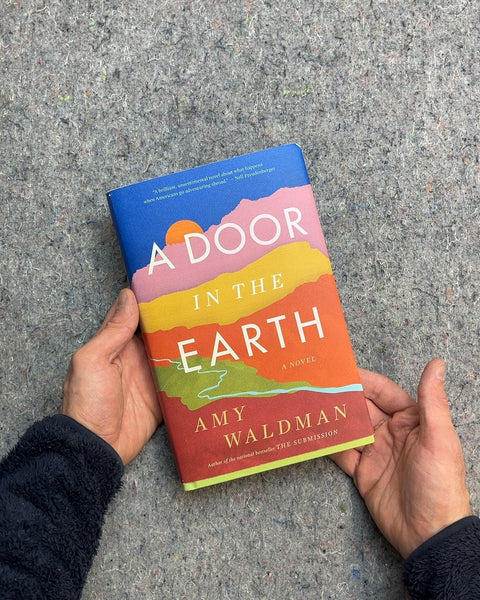 A Door in the Earth Hardcover by Amy Waldman