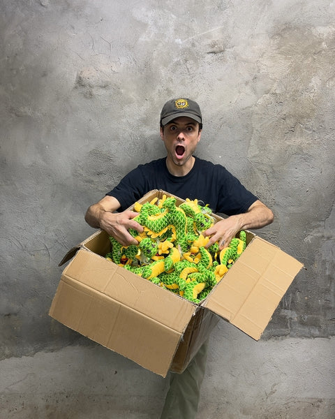 A Whole Box Of Green and Yellow Dragon Plushies