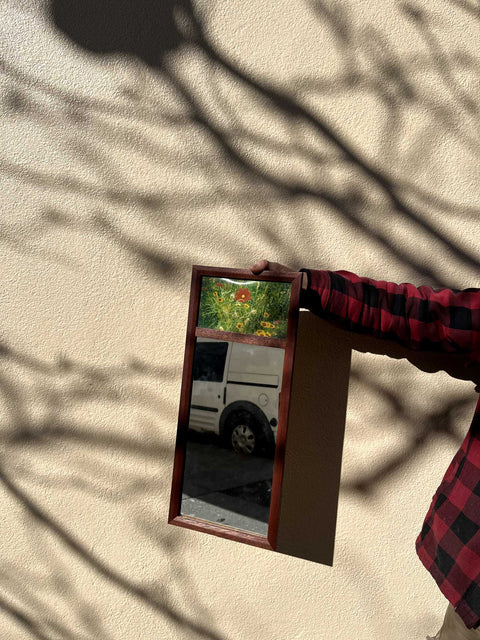 A Decorative Mirror With Floral Art