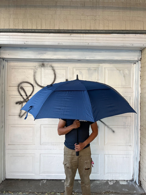 A Serious Large Blue Umbrella With Sleeve