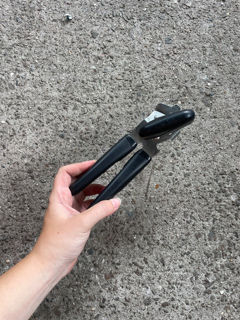 Hand Holding Can Opener