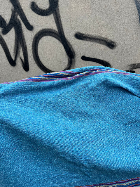 A Pretty Blue Pom Pom Throw Blanket