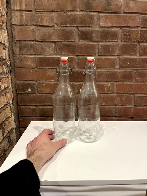 Two Clear Glass Swing-top Bottles