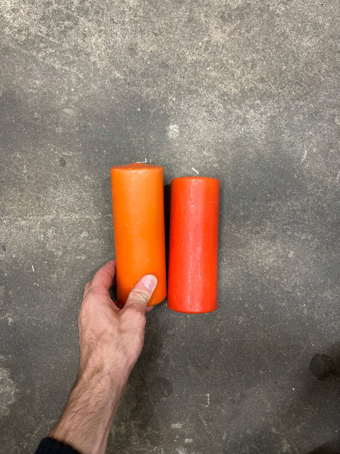 Two Orange Pillar Candles