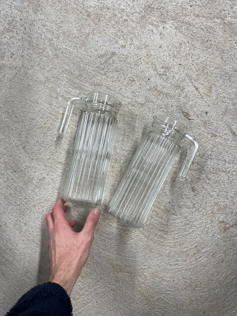 Two Ribbed Glass Water Pitchers