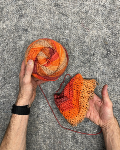 Orange Ombre Variegated Yarn Cake with Started Crochet Piece