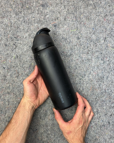 Owala Black Water Bottle That Looks Like It Felt Down The Stairs Or Something