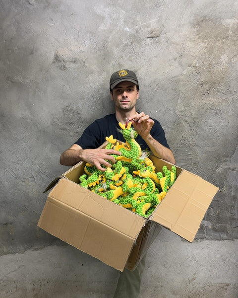 A Whole Box Of Green and Yellow Dragon Plushies