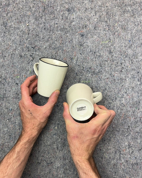 Two Pretty Crate & Barrel Cream Textured Mugs with Black Rim