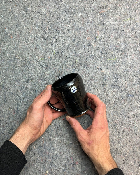 Black Ceramic Mug with White Smiley Face On One Side And Sad Face On The Other