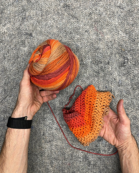 Orange Ombre Variegated Yarn Cake with Started Crochet Piece