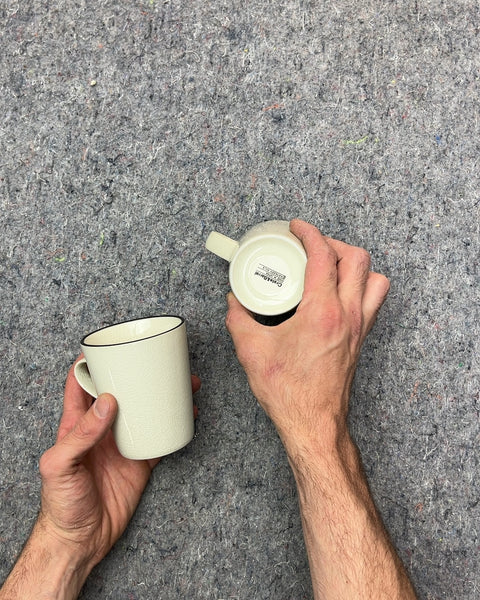 Two Pretty Crate & Barrel Cream Textured Mugs with Black Rim